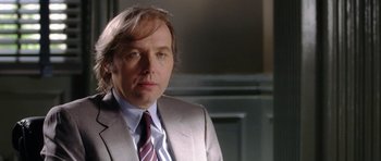 Movie still from “Wedding Crashers” (2005), directed by David Dobkin – A person wearing a suit and tie; Close Up shot, Over the shoulder angle