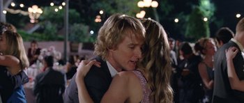 Movie still from “Wedding Crashers” (2005), directed by David Dobkin – A man and a woman hugging each other in front of a crowd of onlookers; Close Up shot, Over the shoulder angle