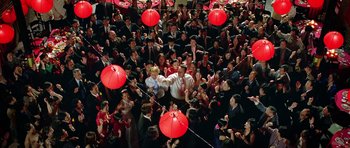 Movie still from “Wedding Crashers” (2005), directed by David Dobkin – A large group of people holding red umbrellas; Extreme Wide shot, Overhead angle