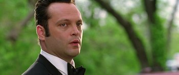 Movie still from “Wedding Crashers” (2005), directed by David Dobkin – A person wearing a suit and tie; Close Up shot, Over the shoulder angle