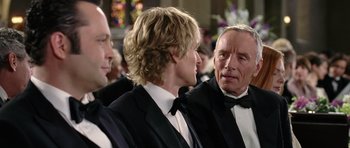 Movie still from “Wedding Crashers” (2005), directed by David Dobkin – A group of men in tuxedos standing next to each other; Close Up shot, Over the shoulder angle