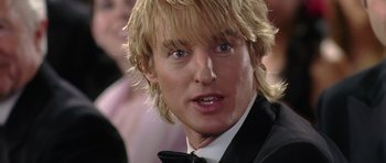 Movie still from “Wedding Crashers” (2005), directed by David Dobkin – A person wearing a suit and tie; Close Up shot, Over the shoulder angle