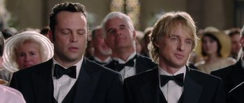 Movie still from “Wedding Crashers” (2005), directed by David Dobkin – A group of men in tuxedos standing next to each other; Close Up shot, Over the shoulder angle