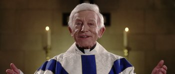 Movie still from “Wedding Crashers” (2005), directed by David Dobkin – An older man wearing a blue and white robe; Close Up shot, Low angle