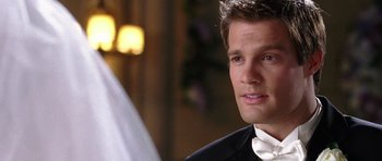 Movie still from “Wedding Crashers” (2005), directed by David Dobkin – A person wearing a suit and tie; Close Up shot, Over the shoulder angle