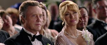 Movie still from “Wedding Crashers” (2005), directed by David Dobkin – A man and a woman standing next to each other in front of a crowd; Close Up shot, Low angle
