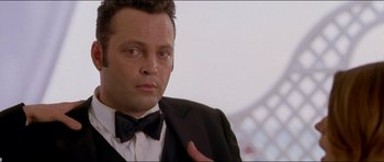 Movie still from “Wedding Crashers” (2005), directed by David Dobkin – A person wearing a suit and a bow tie; Close Up shot, Low angle