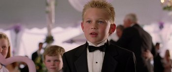 Movie still from “Wedding Crashers” (2005), directed by David Dobkin – A young boy in a suit and bow tie; Close Up shot, Low angle