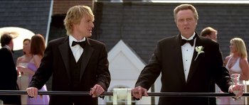 Movie still from “Wedding Crashers” (2005), directed by David Dobkin – Two men in tuxedos standing next to each other; Medium shot, Low angle