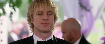 Movie still from “Wedding Crashers” (2005), directed by David Dobkin – A person wearing a suit and bow tie; Close Up shot, Over the shoulder angle