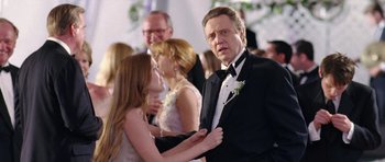 Movie still from “Wedding Crashers” (2005), directed by David Dobkin – A man in a tuxedo holding a woman in a dress; Close Up shot, Over the shoulder angle