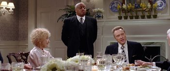 Movie still from “Wedding Crashers” (2005), directed by David Dobkin – A group of people sitting around a table; Medium shot, Over the shoulder angle
