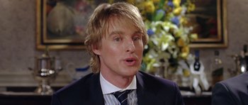 Movie still from “Wedding Crashers” (2005), directed by David Dobkin – A person wearing a suit and tie; Close Up shot, Over the shoulder angle