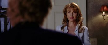 Movie still from “Wedding Crashers” (2005), directed by David Dobkin – A woman with long red hair is looking at a man in a suit; Close Up shot, Over the shoulder angle