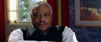 Movie still from “Wedding Crashers” (2005), directed by David Dobkin – An older man wearing a black vest and a white shirt; Close Up shot, Low angle