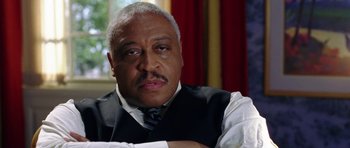 Movie still from “Wedding Crashers” (2005), directed by David Dobkin – An older man wearing a vest and tie; Close Up shot, Low angle