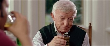 Movie still from “Wedding Crashers” (2005), directed by David Dobkin – An older man holding a glass in his hand; Close Up shot, Over the shoulder angle