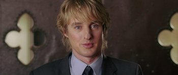 Movie still from “Wedding Crashers” (2005), directed by David Dobkin – A person wearing a suit and tie; Close Up shot, Over the shoulder angle