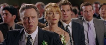 Movie still from “Wedding Crashers” (2005), directed by David Dobkin – A group of people standing next to each other in a room; Close Up shot, Over the shoulder angle