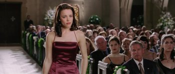 Movie still from “Wedding Crashers” (2005), directed by David Dobkin – A woman standing in front of a group of people; Medium shot, Over the shoulder angle