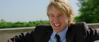 Movie still from “Wedding Crashers” (2005), directed by David Dobkin – A person wearing a suit and tie smiling; Close Up shot, Low angle