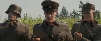 Movie still from “Welcome to Marwen” (2018), directed by Robert Zemeckis – A man in a military uniform is holding a knife; Close Up shot, Over the shoulder angle