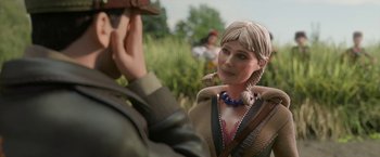 Movie still from “Welcome to Marwen” (2018), directed by Robert Zemeckis – A statue of a woman and a man in a field; Close Up shot, Over the shoulder angle