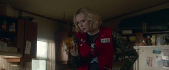 Movie still from “Welcome to Marwen” (2018), directed by Robert Zemeckis – A woman holding a pill bottle in her hand; Medium shot, Over the shoulder angle