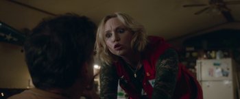 Movie still from “Welcome to Marwen” (2018), directed by Robert Zemeckis – A woman in a red vest is looking at a woman in a red vest; Close Up shot, Over the shoulder angle