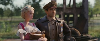 Movie still from “Welcome to Marwen” (2018), directed by Robert Zemeckis – A man and a woman standing next to each other; Medium shot, Over the shoulder angle