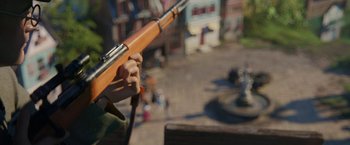 Movie still from “Welcome to Marwen” (2018), directed by Robert Zemeckis – A person holding a rifle in their hand; Extreme Close Up shot, High angle