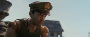 Movie still from “Welcome to Marwen” (2018), directed by Robert Zemeckis – A person wearing a hat; Close Up shot, Over the shoulder angle
