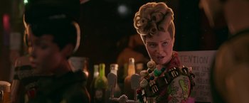 Movie still from “Welcome to Marwen” (2018), directed by Robert Zemeckis – A woman with a bunch of hair on her head; Close Up shot, Over the shoulder angle