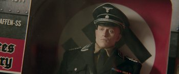 Movie still from “Welcome to Marwen” (2018), directed by Robert Zemeckis – A person wearing a military uniform; Close Up shot, High angle