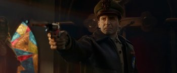 Movie still from “Welcome to Marwen” (2018), directed by Robert Zemeckis – A man wearing a hat and holding a gun; Close Up shot, Over the shoulder angle