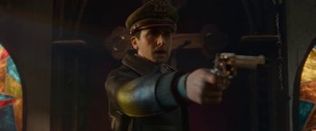 Movie still from “Welcome to Marwen” (2018), directed by Robert Zemeckis – A man in a military uniform is holding a gun; Close Up shot, Over the shoulder angle