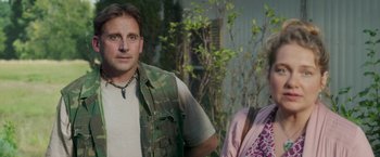 Movie still from “Welcome to Marwen” (2018), directed by Robert Zemeckis – A man and a woman standing next to each other in front of trees; Medium shot, Over the shoulder angle