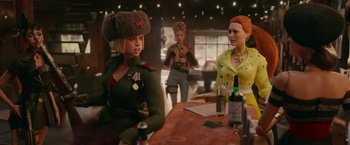 Movie still from “Welcome to Marwen” (2018), directed by Robert Zemeckis – A group of women sitting at a table with a bottle of wine; Medium shot, Over the shoulder angle