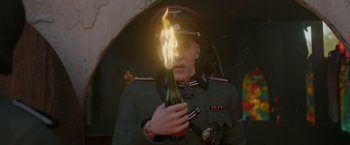 Movie still from “Welcome to Marwen” (2018), directed by Robert Zemeckis – A man in a uniform holding a bottle of wine; Close Up shot, Low angle