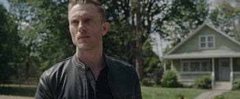 Movie still from “Welcome to Marwen” (2018), directed by Robert Zemeckis – A person wearing a black shirt; Close Up shot, Over the shoulder angle