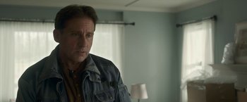 Movie still from “Welcome to Marwen” (2018), directed by Robert Zemeckis – A man standing in front of a mirror in a room; Close Up shot, Over the shoulder angle