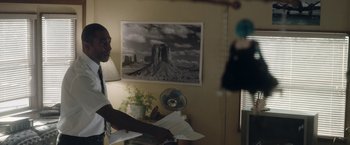 Movie still from “Welcome to Marwen” (2018), directed by Robert Zemeckis – A man standing in front of a picture of a mountain; Medium shot, Over the shoulder angle