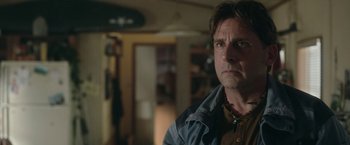 Movie still from “Welcome to Marwen” (2018), directed by Robert Zemeckis – A person wearing a jacket in a room; Close Up shot, Over the shoulder angle