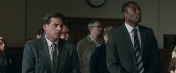 Movie still from “Welcome to Marwen” (2018), directed by Robert Zemeckis – A group of people standing in front of a wall clock; Medium shot, Low angle