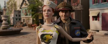 Movie still from “Welcome to Marwen” (2018), directed by Robert Zemeckis – A man and a woman are standing next to each other; Medium shot, Over the shoulder angle