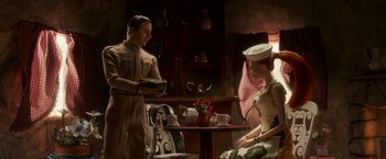 Movie still from “Welcome to Marwen” (2018), directed by Robert Zemeckis – A man and a woman dressed in vintage clothing in a room; Wide shot, Low angle