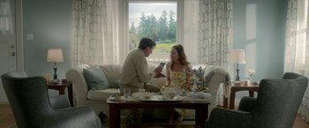 Movie still from “Welcome to Marwen” (2018), directed by Robert Zemeckis – A man and a woman sitting at a table with food; Wide shot, Low angle