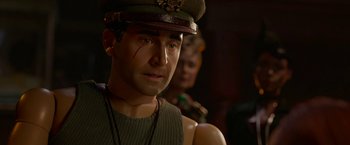 Movie still from “Welcome to Marwen” (2018), directed by Robert Zemeckis – A person wearing a hat; Close Up shot, Over the shoulder angle