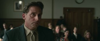 Movie still from “Welcome to Marwen” (2018), directed by Robert Zemeckis – A person wearing a suit and tie; Close Up shot, Low angle