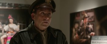 Movie still from “Welcome to Marwen” (2018), directed by Robert Zemeckis – A man in a military uniform looking at a mirror; Close Up shot, Over the shoulder angle